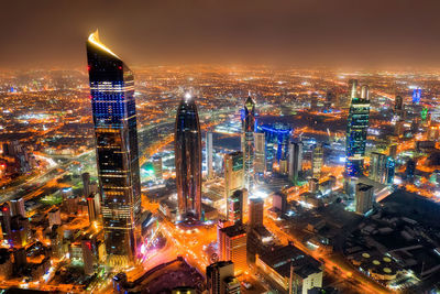 High angle view of illuminated buildings in city at night