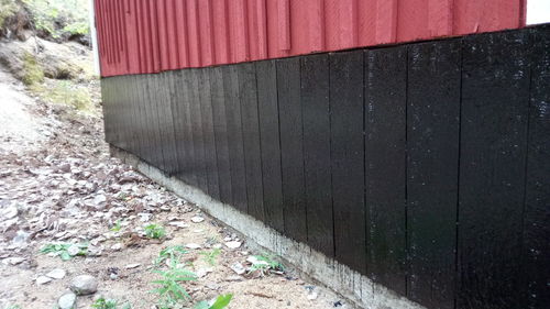 Close-up of red door on field