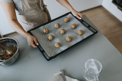 Woman in kitchen preparing cookies