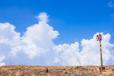 Road sign against sky