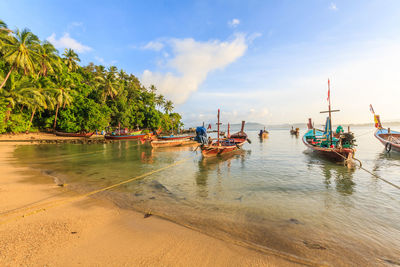 Boats moored on sea against sky