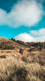 Man on field against sky