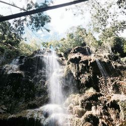 Low angle view of waterfall against sky