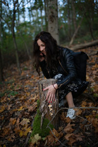 Young woman looking away in forest