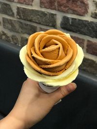 Close-up of hand holding ice cream