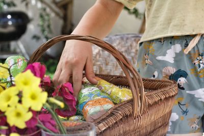 Low section of woman in wicker basket