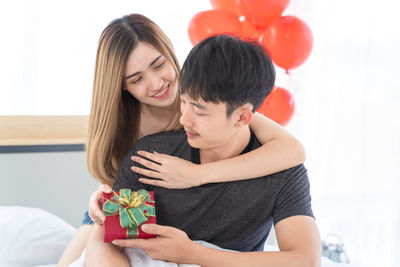 Young couple holding hands in box