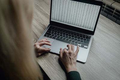 The hands of girl are typing in a laptop. workspace work at home. online business. distance learning