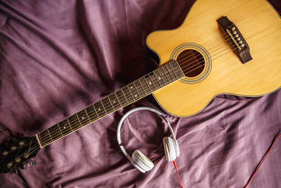 High angle view of playing guitar on bed