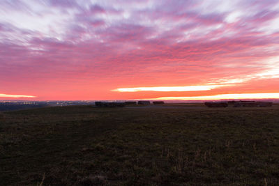 Scenic view of field against sky during sunset