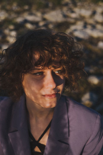 Woman looking away outdoors in sunny day