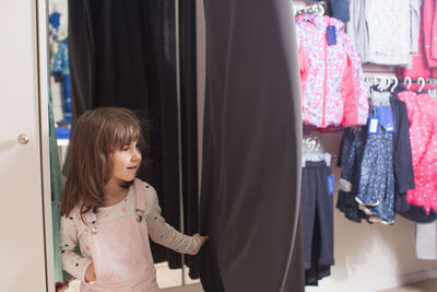 Girl looking away while standing in store