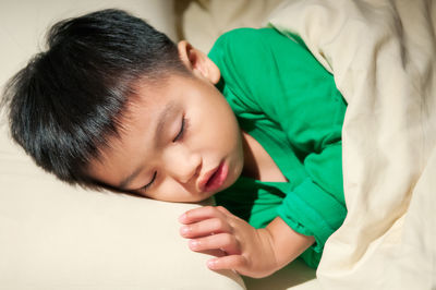 Close-up of boy sleeping in bed