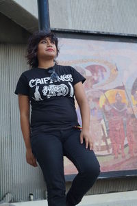 Close-up of woman standing against wall