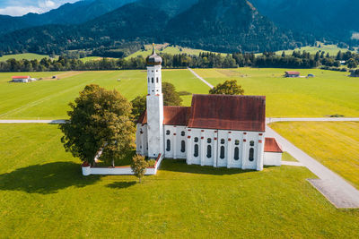 Aerial view of church near schwangau on summer day with alps in background