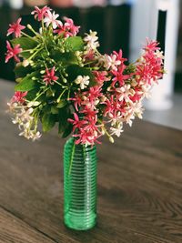 Close-up of red flower vase on table