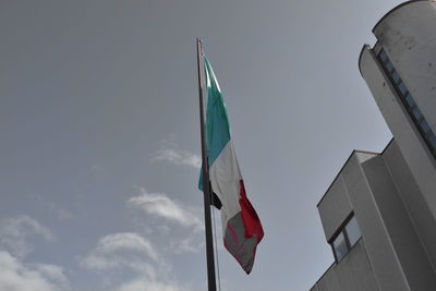 Low angle view of flag flags against sky