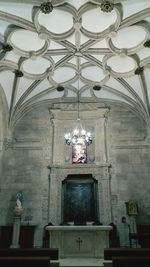 Low angle view of illuminated chandelier hanging in building