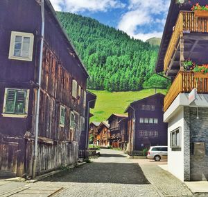 Empty road with buildings in background