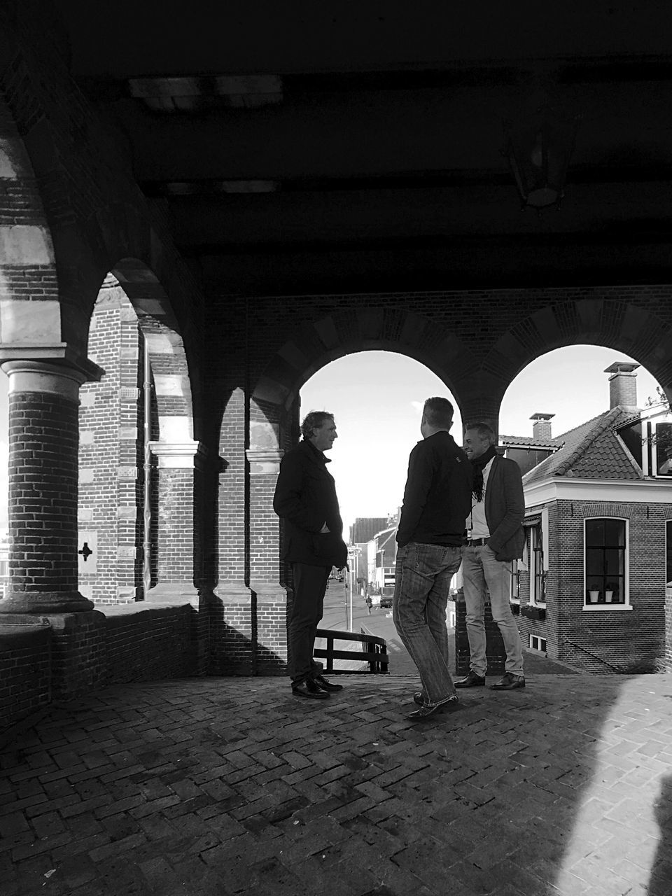 MEN STANDING AT ARCHWAY