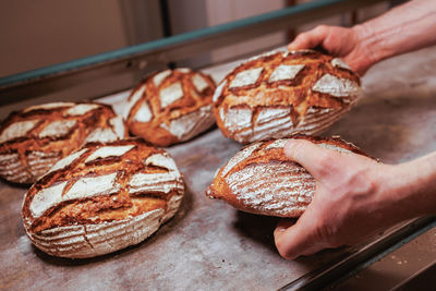 Close-up of bread with hands in bakery