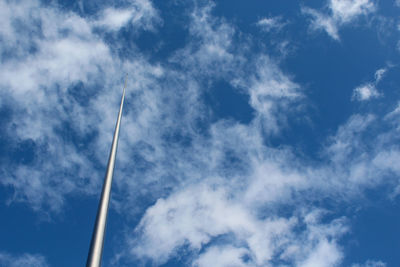 Low angle view of vapor trail against blue sky