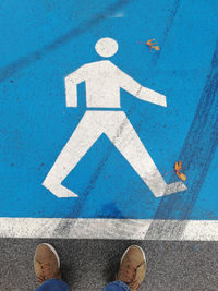 Low section of person standing on road