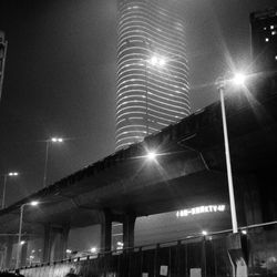 Low angle view of illuminated building against sky at night