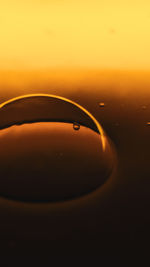 Close-up of silhouette water against orange sky