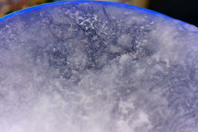 Close-up of ice against blue sky