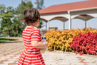 Rear view of cute infant girl in the park