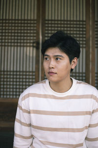 Portrait of young man standing outdoors