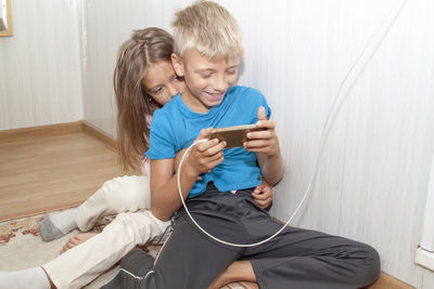 Happy boy using mobile phone