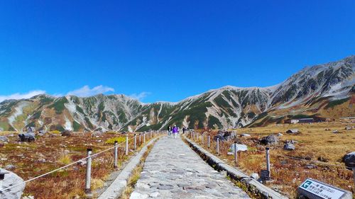 Scenic view of mountains against blue sky