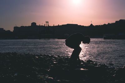 Silhouette of woman at sunset