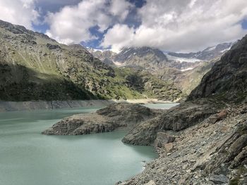 Scenic view of lake and mountains against sky