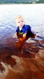 Portrait of cute boy in water
