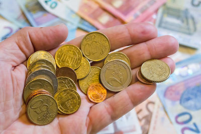 Close-up of hand holding coins