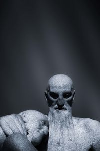 Close-up of statue against stone wall