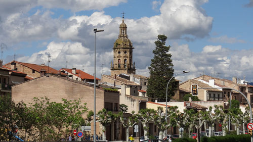 Panoramic view of buildings in town against sky