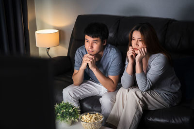 Young couple sitting on sofa