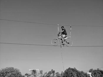 Low angle view of man skateboarding against sky