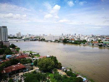 High angle view of city against cloudy sky