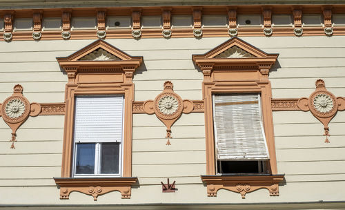 Low angle view of house hanging on building