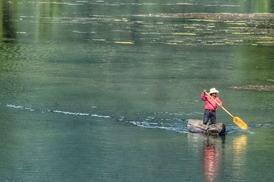 Man surfing on boat in water