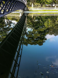 Reflection of bridge on lake at pasir ris park