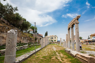 Tourists visiting the ancient ruins at the roman agora in athens