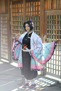 Portrait of young woman holding umbrella