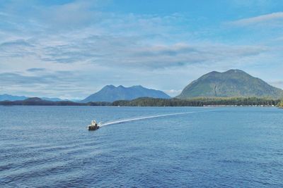 Scenic view of sea and mountains against sky