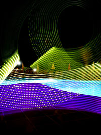 Low angle view of illuminated lighting equipment at night